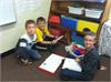 4th Graders enjoy sharing poetry folders with their kindergarten friends. 